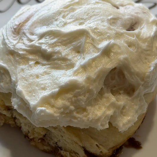 Fresh-baked cinnamon roll in Reno, NV topped with rich cream cheese frosting
