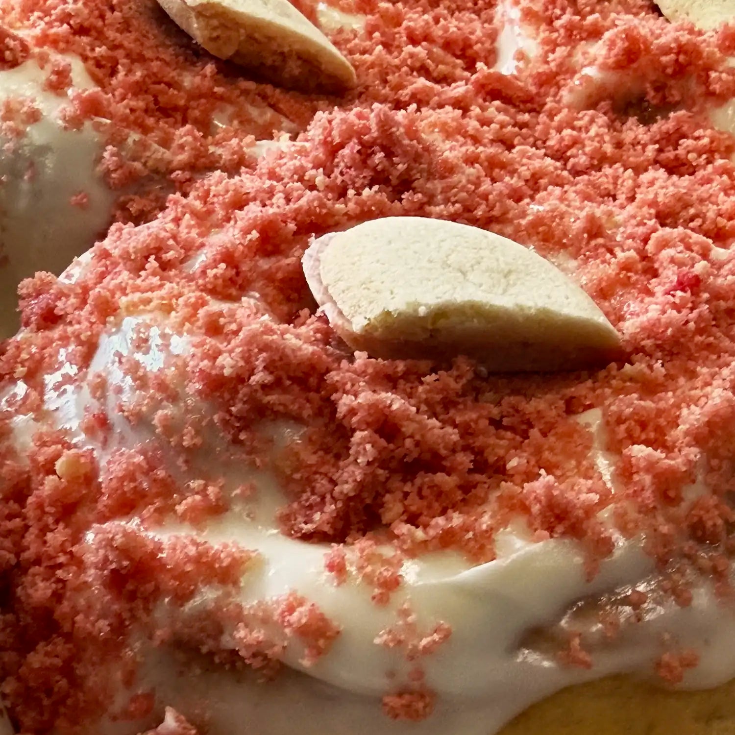 Strawberry cheesecake cinnamon roll in Reno, NV with creamy frosting and strawberry crunch